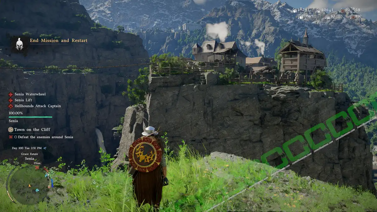 Player character in a fantasy armor stands on a grassy cliff, shield on back, overlooking a rocky outcrop with wooden houses and a small village atop the cliff. In-game UI shows mission title 'End Mission and Restart' and objective text on the left, and a minimap bottom-left. Where Land Meets Sky Parish - Senia - location - Crimson Desert camzillasmom.com